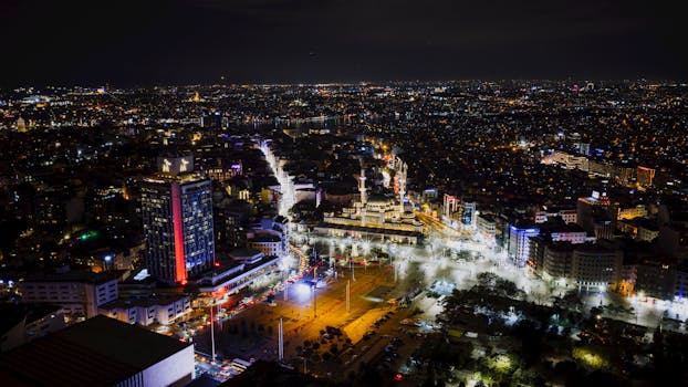 A spectacular aerial night view of Istanbul showcasing its vibrant city lights and architecture.