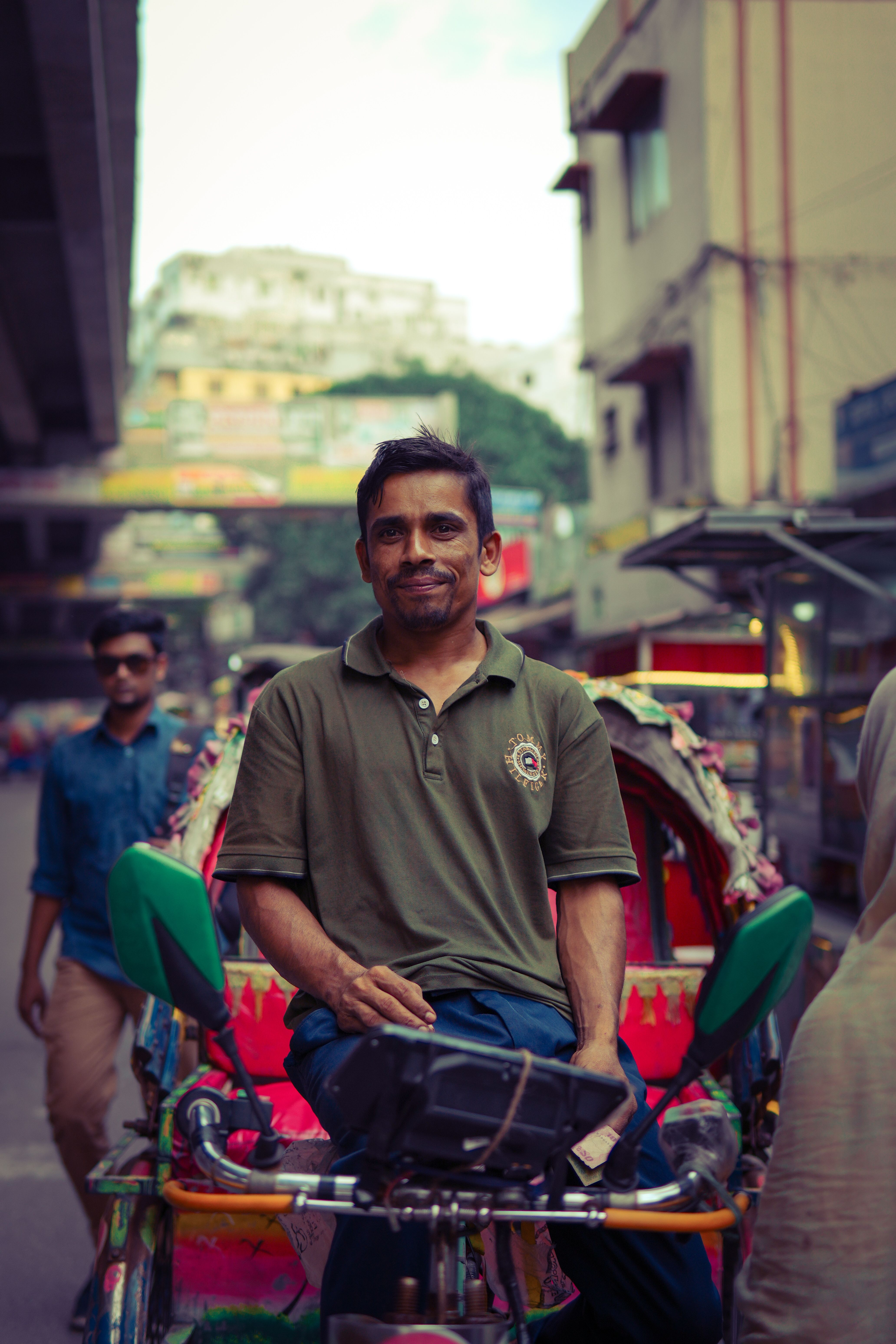 Smiling Rickshaw Driver in Bustling Street · Free Stock Photo
