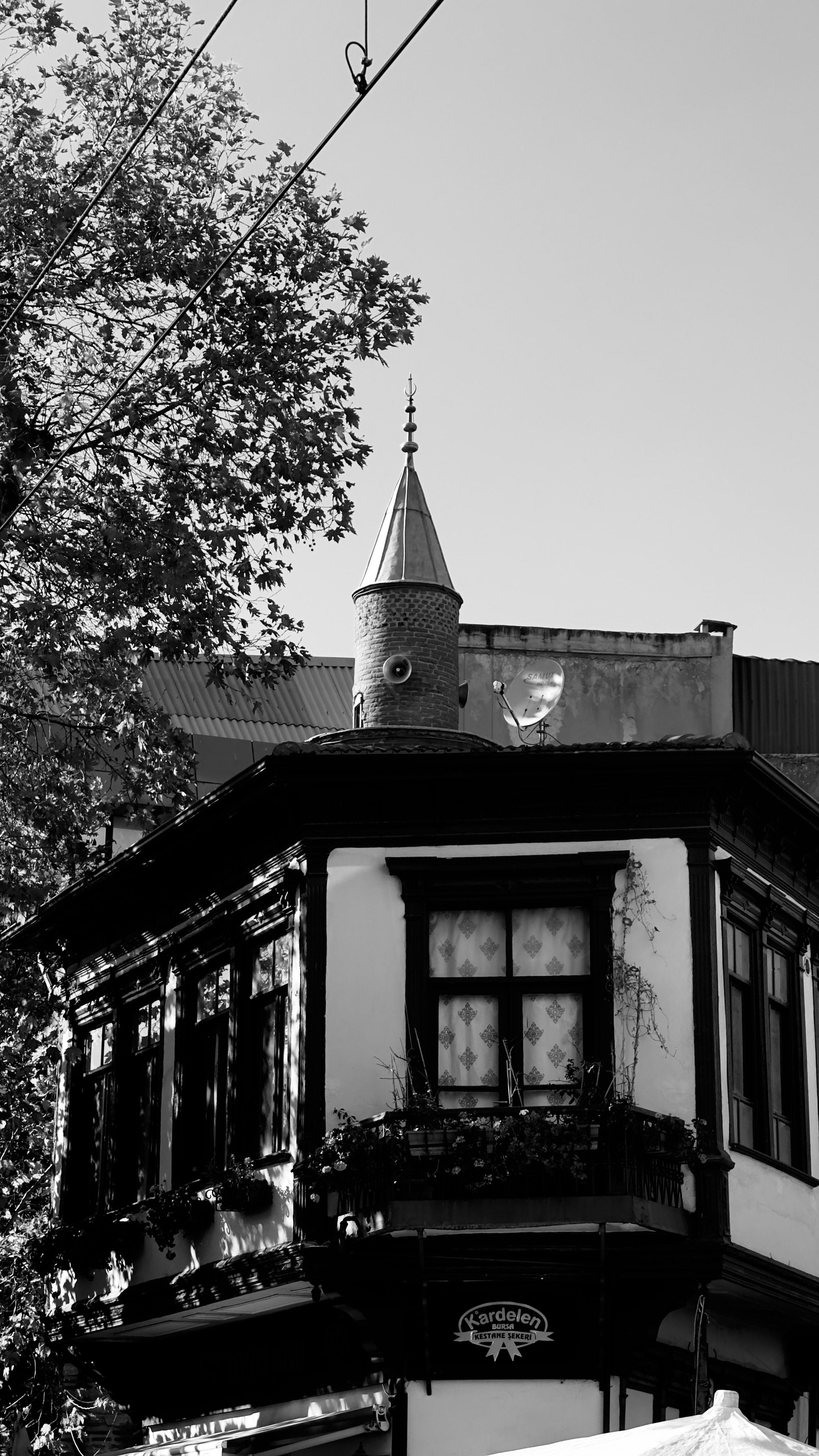 Detailed black and white photo of an old European-style building with turret.