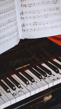 A songwriter practicing jazz-inflected chords on a piano to improve their composition.