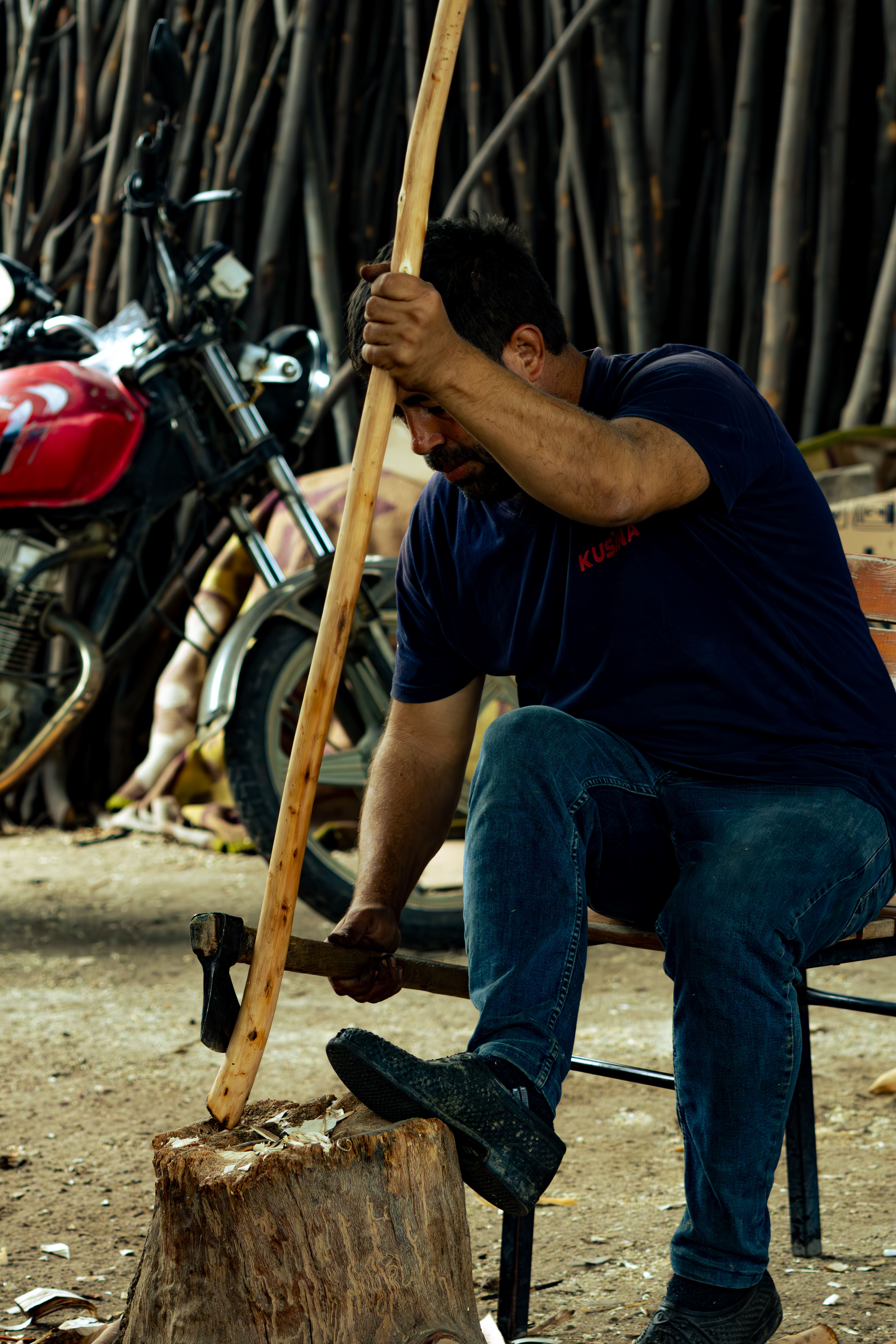A craftsman skillfully hand-carves wood in a workshop in Manisa, Türkiye.