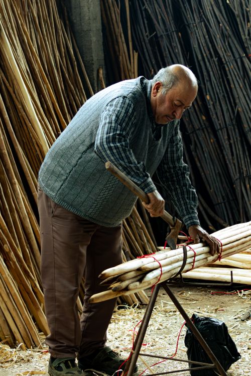 Free Elderly man crafting bamboo products with a knife in a workshop in Manisa, Turkey. Stock Photo
