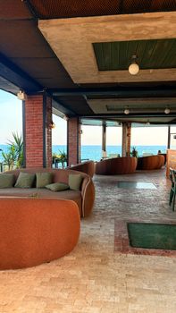 Elegant indoor lounge overlooking the ocean with stylish seating and decor.