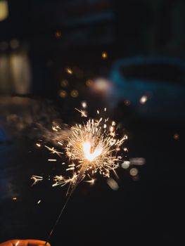 Close-up of a lit sparkler creating a festive and celebratory ambiance.