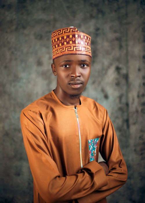 Free A young man wearing traditional Nigerian attire with patterned hat posing indoors. Stock Photo