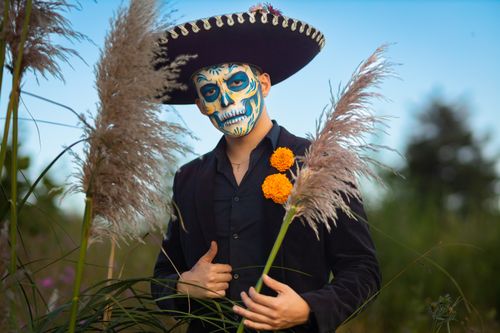Free Colorful Day of the Dead Catrina portrait with charro hat and flowers outdoors in México. Stock Photo
