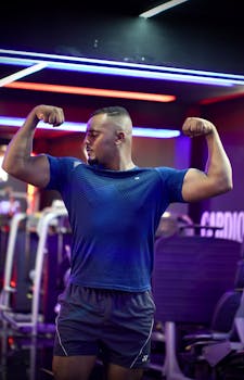 Strong man showcasing biceps in a modern gym setting in Morocco.