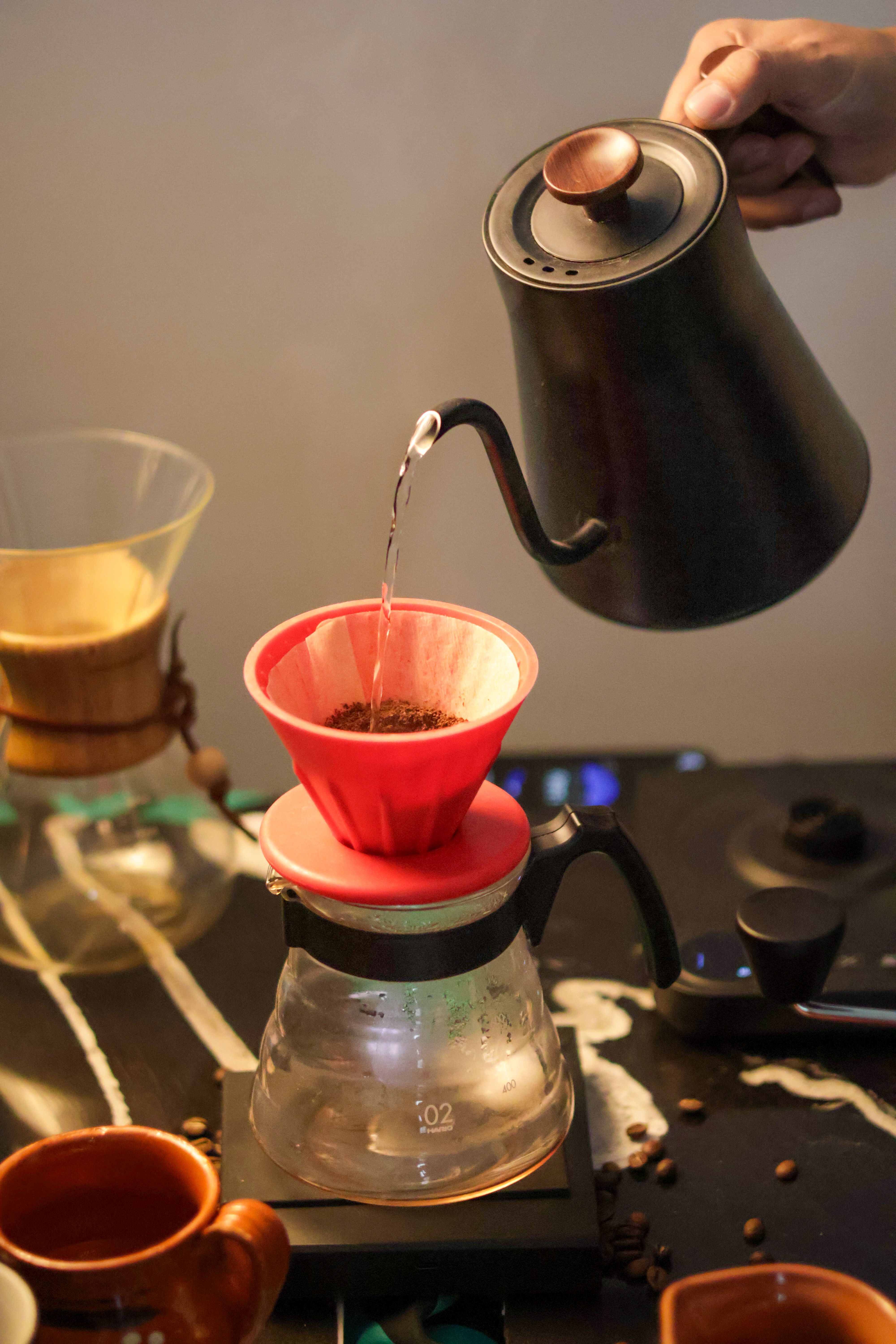 Close-up of hot water spiralling into a pour-over dripper at the Hearth and Oak brew bar