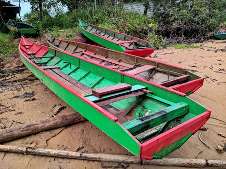 Vividly painted traditional boats resting on a riverbank in North Kalimantan, Indonesia.
