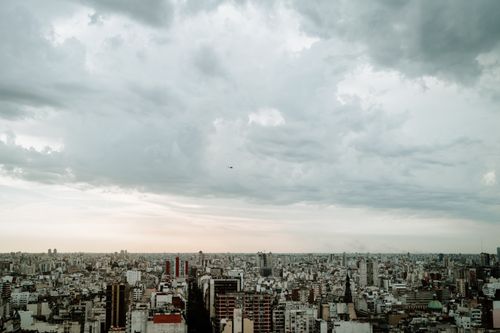 Free A panoramic aerial view of Buenos Aires skyline under a cloudy sky, emphasizing urban density. Stock Photo