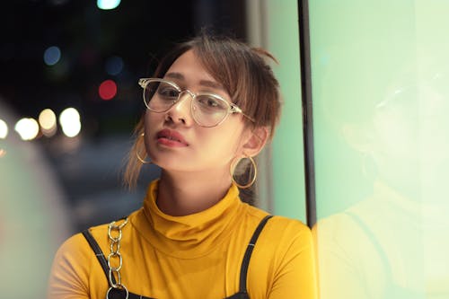 Woman Leaning on Glass Wall