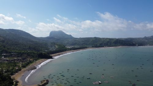 Free Stunning aerial landscape of a beach and mountain in Indonesia, showcasing natural beauty. Stock Photo