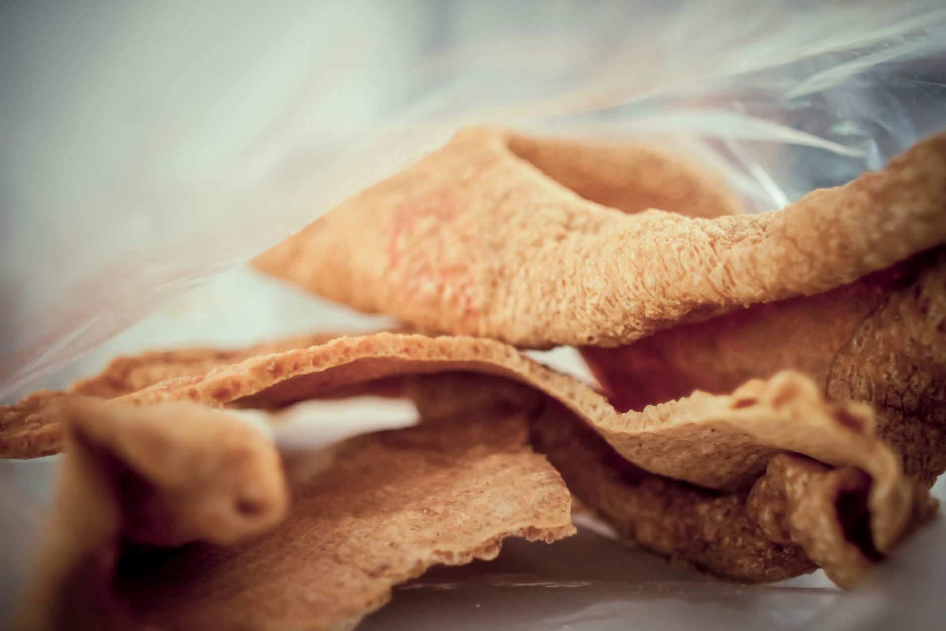 Golden crispy pork cracklings fresh from deep fryer