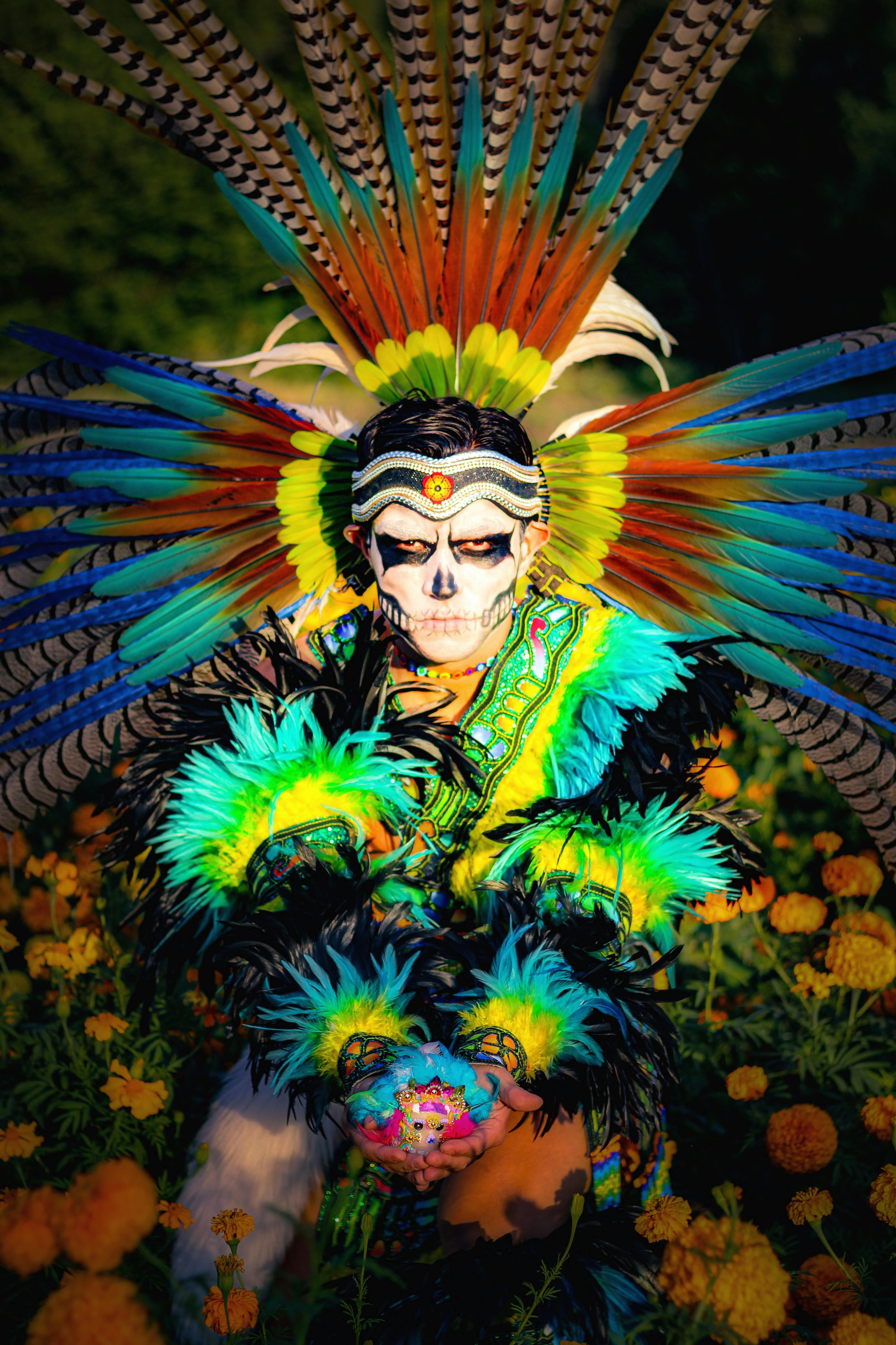Colorful feathered costume and makeup for Day of the Dead celebration in Santiago de Querétaro, Mexico.