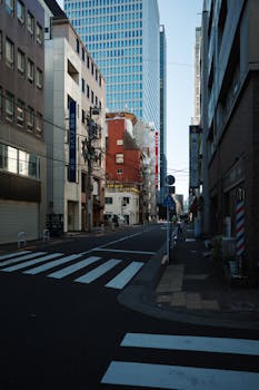 Serene street scene in Minato, Tokyo, Japan with modern skyscrapers and urban architecture.