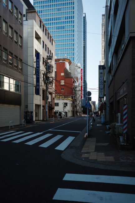 Serene street scene in Minato, Tokyo, Japan with modern skyscrapers and urban architecture.