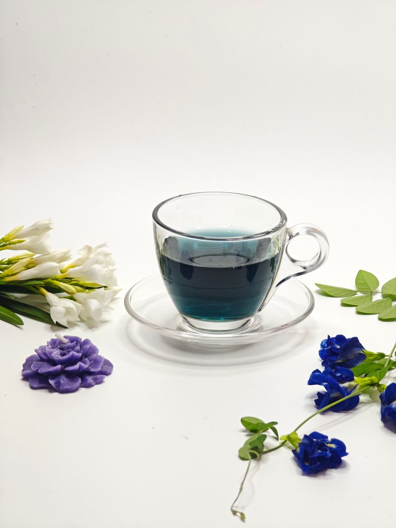 An elegant Japanese tea set with delicate floral cups on a wooden table