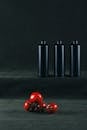 Minimalist Composition of Red Tomatoes and Black Bottles