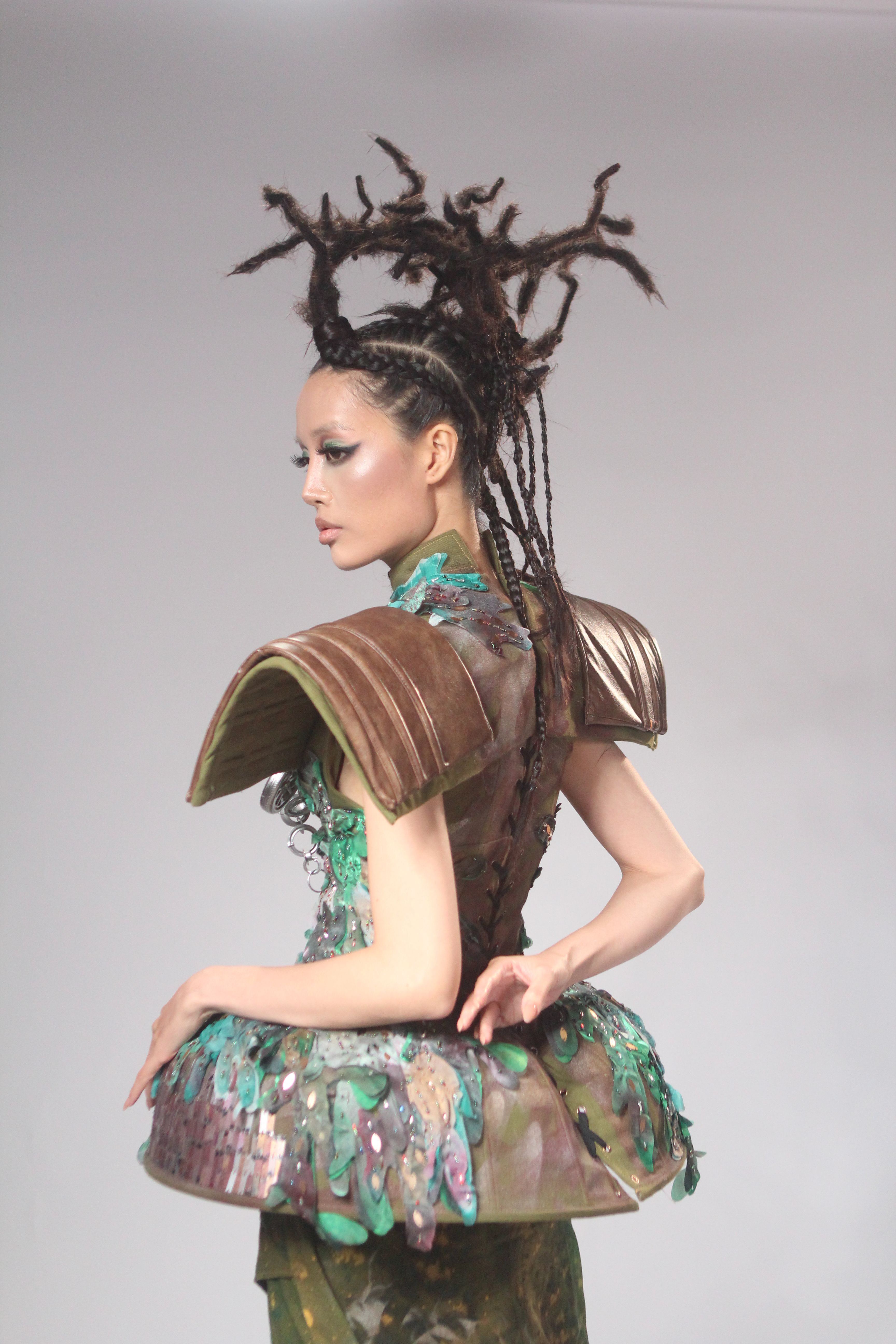 Unique fashion portrait depicting avant-garde design and elaborate hairstyle.