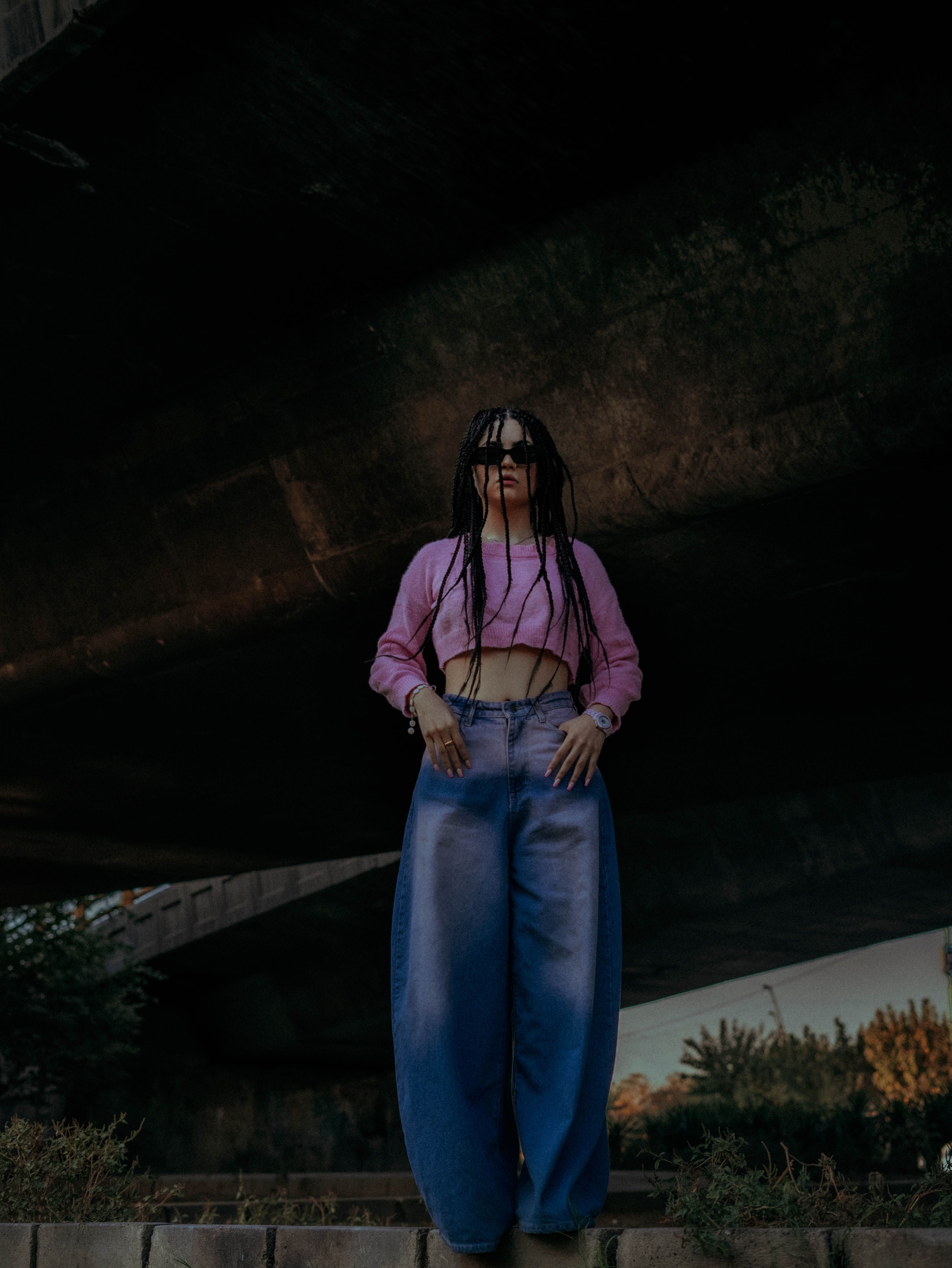 Stylish Woman Posing Under Urban Bridge · Free Stock Photo
