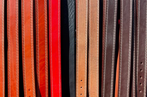 Free A vibrant collection of leather belts displayed vertically, showcasing various colors and textures. Stock Photo