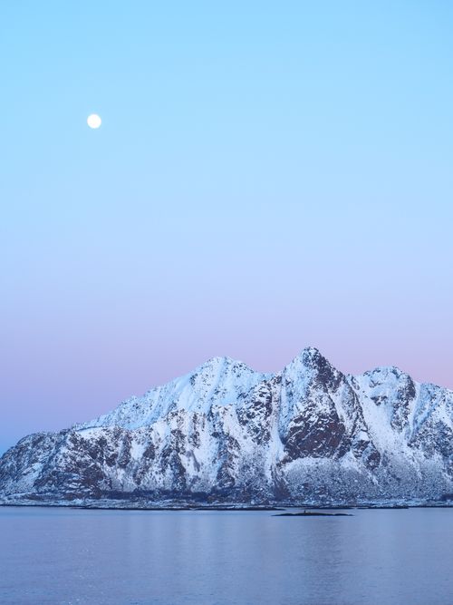 Free Serene snow-covered mountain under a pastel moonlit sky, reflecting tranquility. Stock Photo