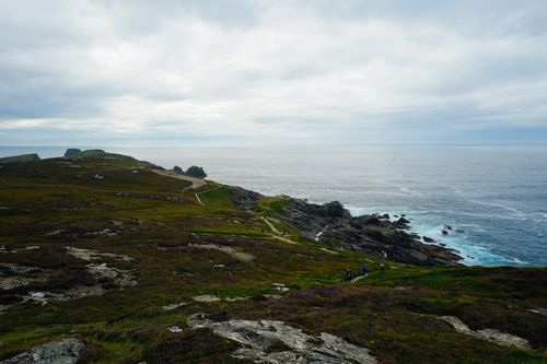 Free Breathtaking view of the rugged coastline with lush green hills and ocean. Stock Photo