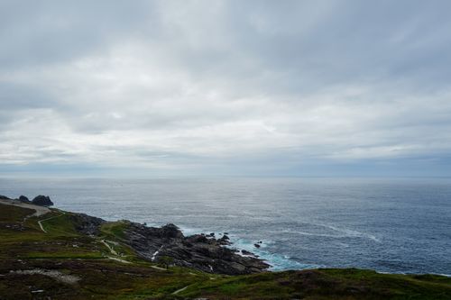 Free Stunning view of rocky cliffs and the ocean under a cloudy sky, perfect for nature lovers. Stock Photo