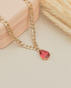 Gold chain with a ruby pendant on a jewellery box — photo by Laura Oliveira on Pexels