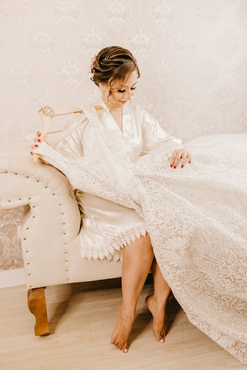 Woman Sitting and Holding Wedding Dress