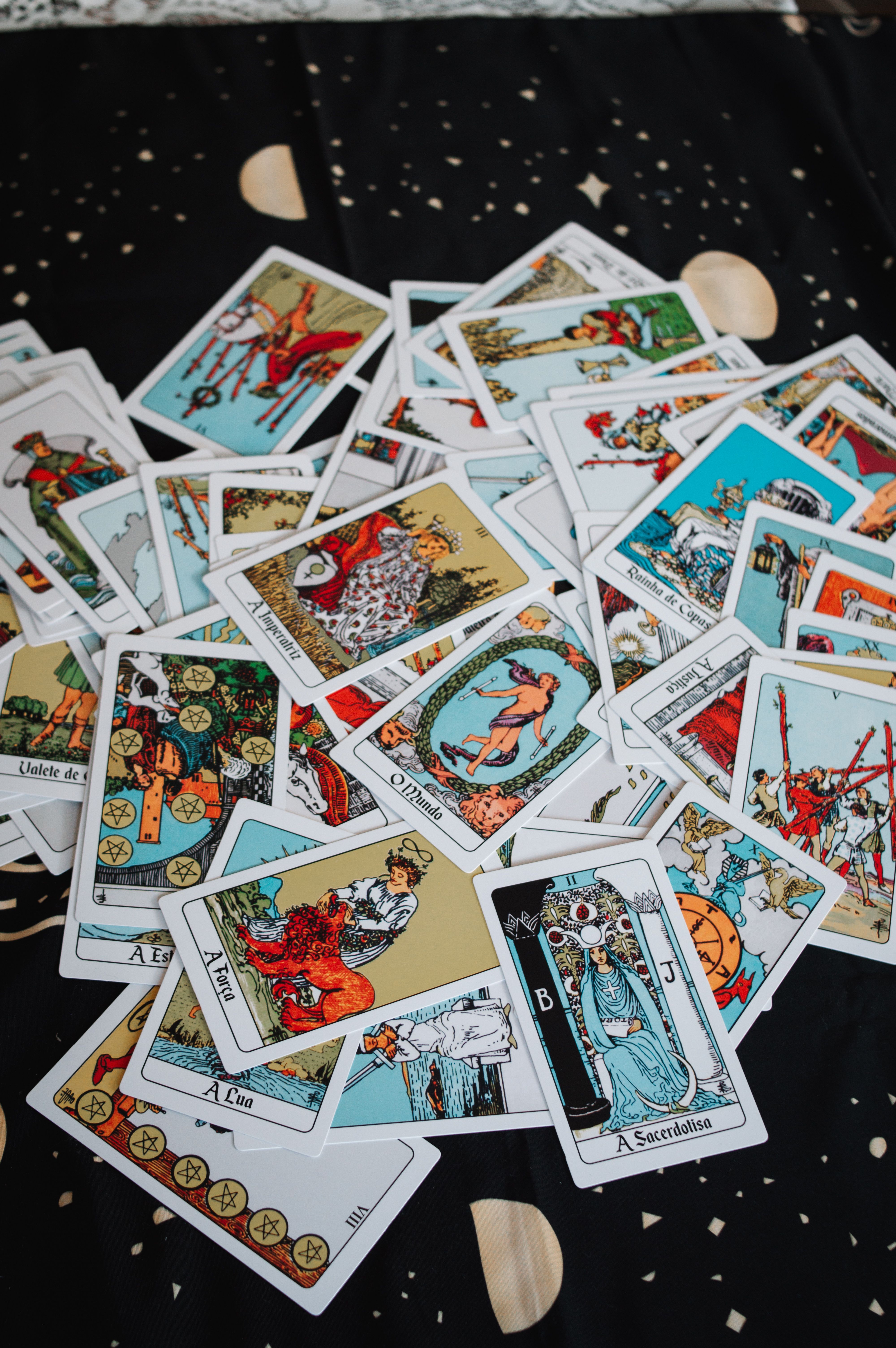 A scattered collection of tarot cards used for spiritual guidance and fortune-telling.