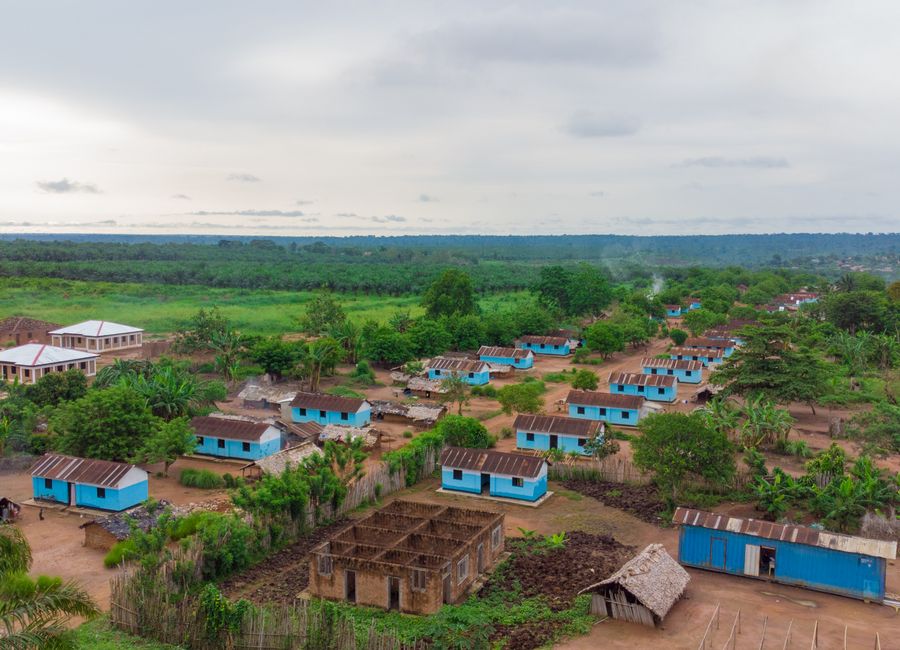 Aerial shot capturing the rural village landscape in DR Congo's lush green environment.