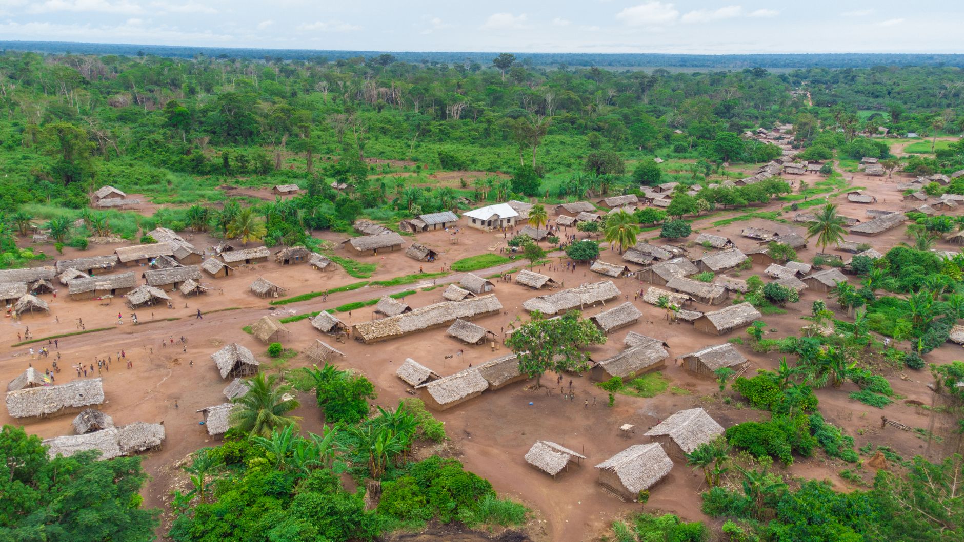 Aerial shot of a rural village surrounded by lush greenery in the Democratic Republic of the Congo.
