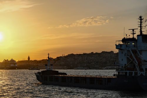Free Stunning sunset over İstanbul with a cargo ship and silhouette of Galata Tower on the Bosporus. Stock Photo