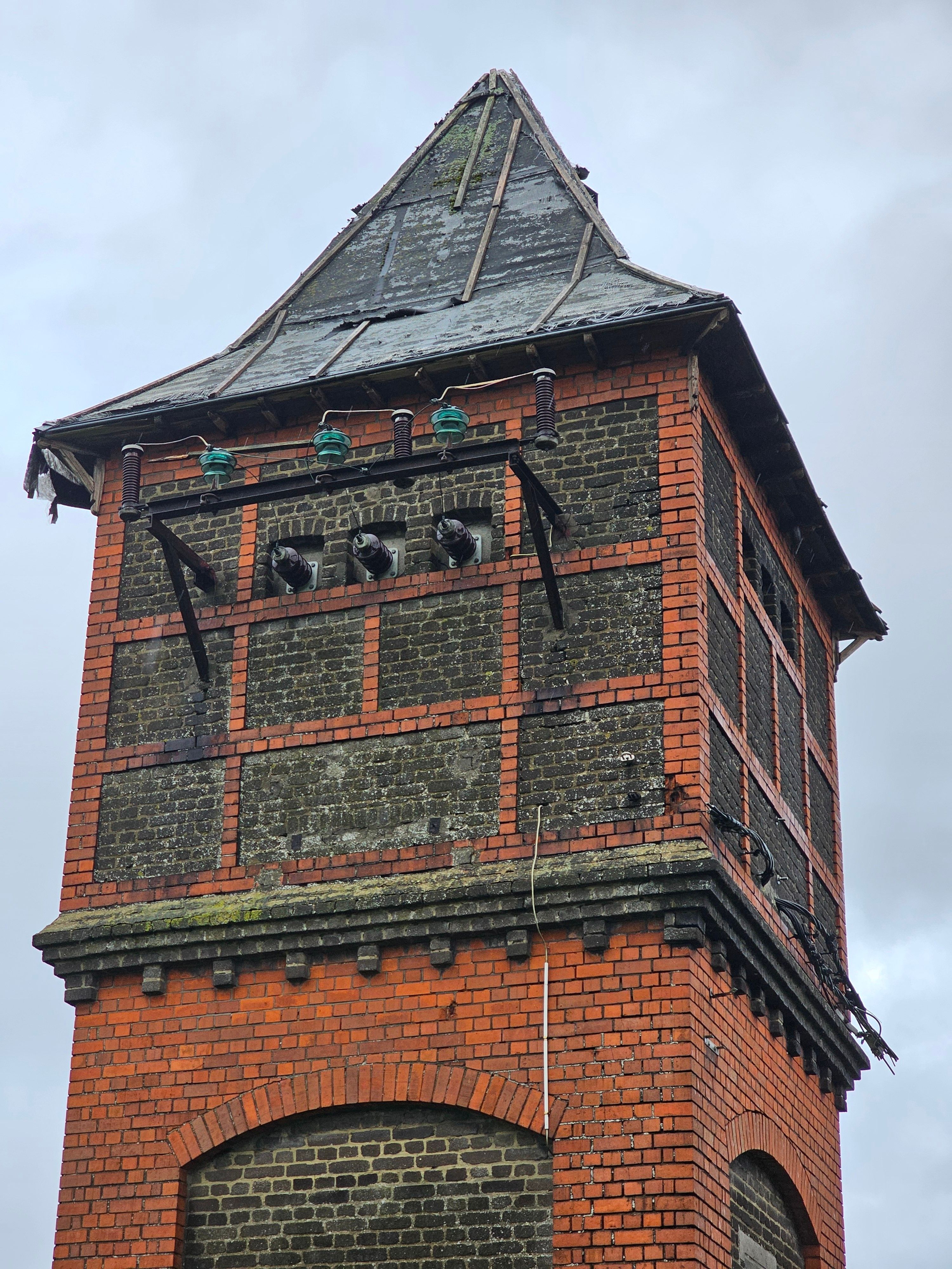 Historic Brick Water Tower Against Cloudy Sky · Free Stock Photo