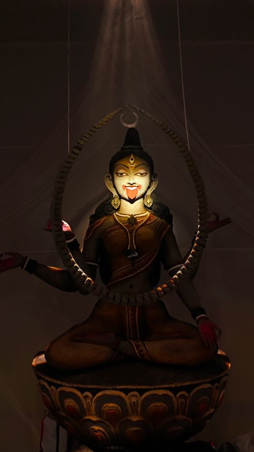 Free A dramatic sculpture of an Indian goddess, elegantly lit in a dark room creating a mystical ambiance. Stock Photo