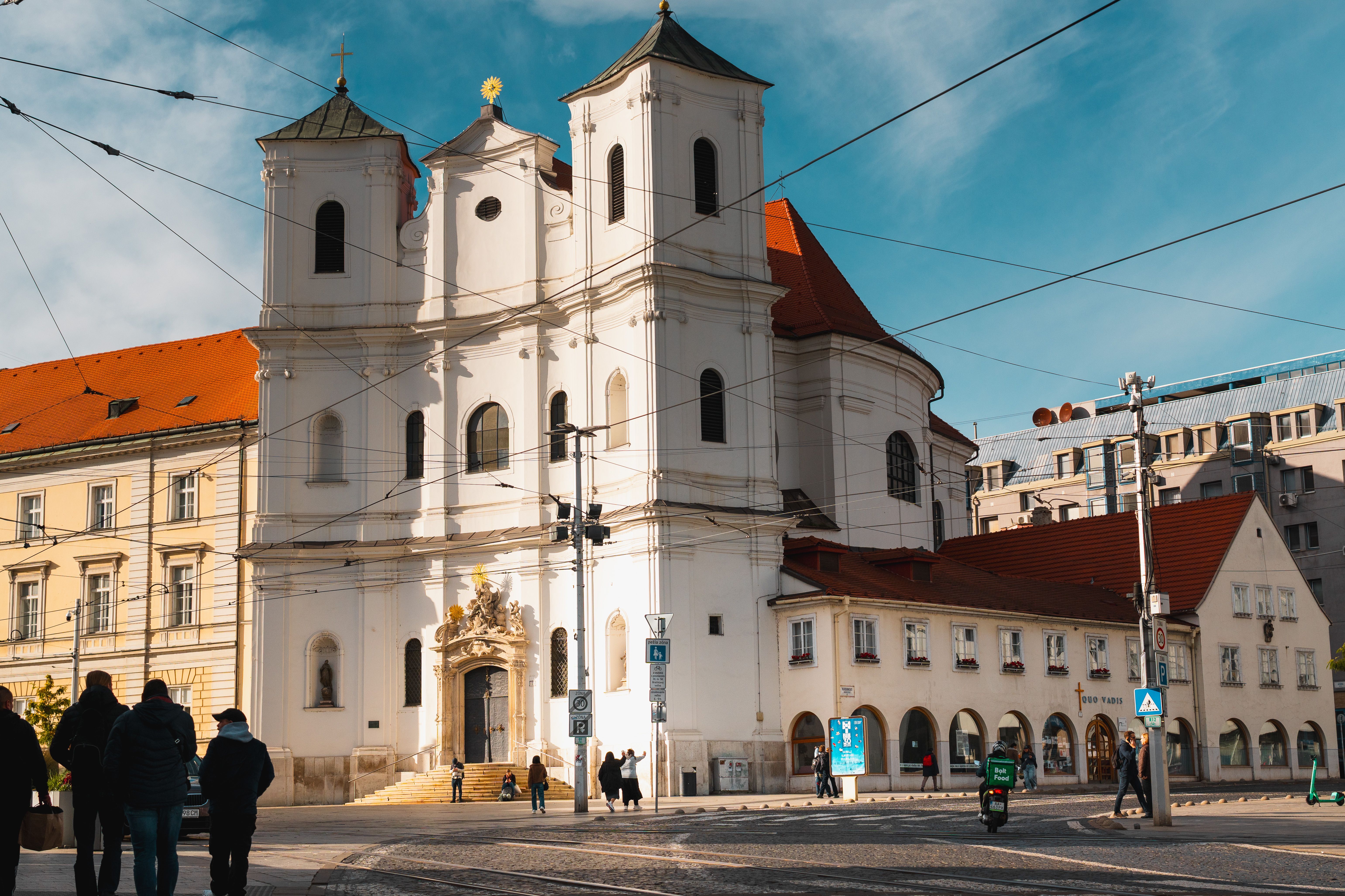 A picturesque street scene in Bratislava featuring historic architecture under a blue sky.