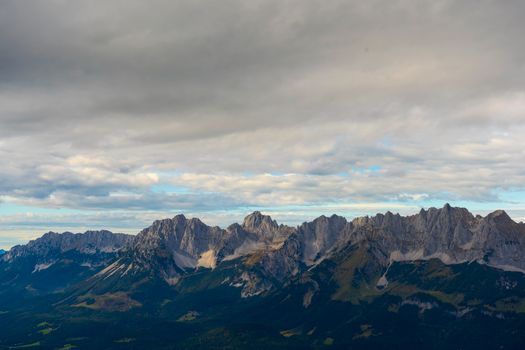 Majestic mountain range under a cloudy sky creating a dramatic landscape.