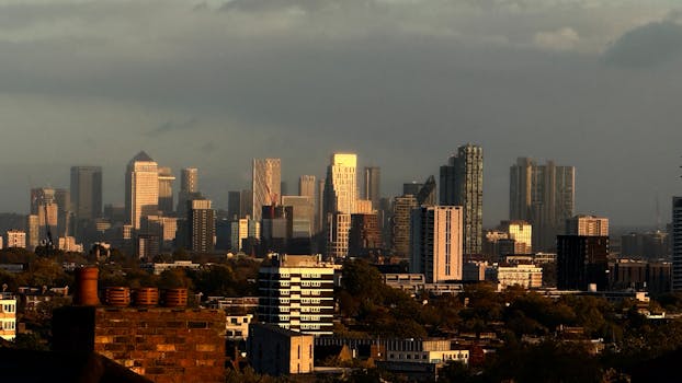 Stunning evening view of London's skyline with modern skyscrapers glowing in sunset light.