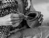 Hands holding mate cup in Uruguay showcasing traditional drink.