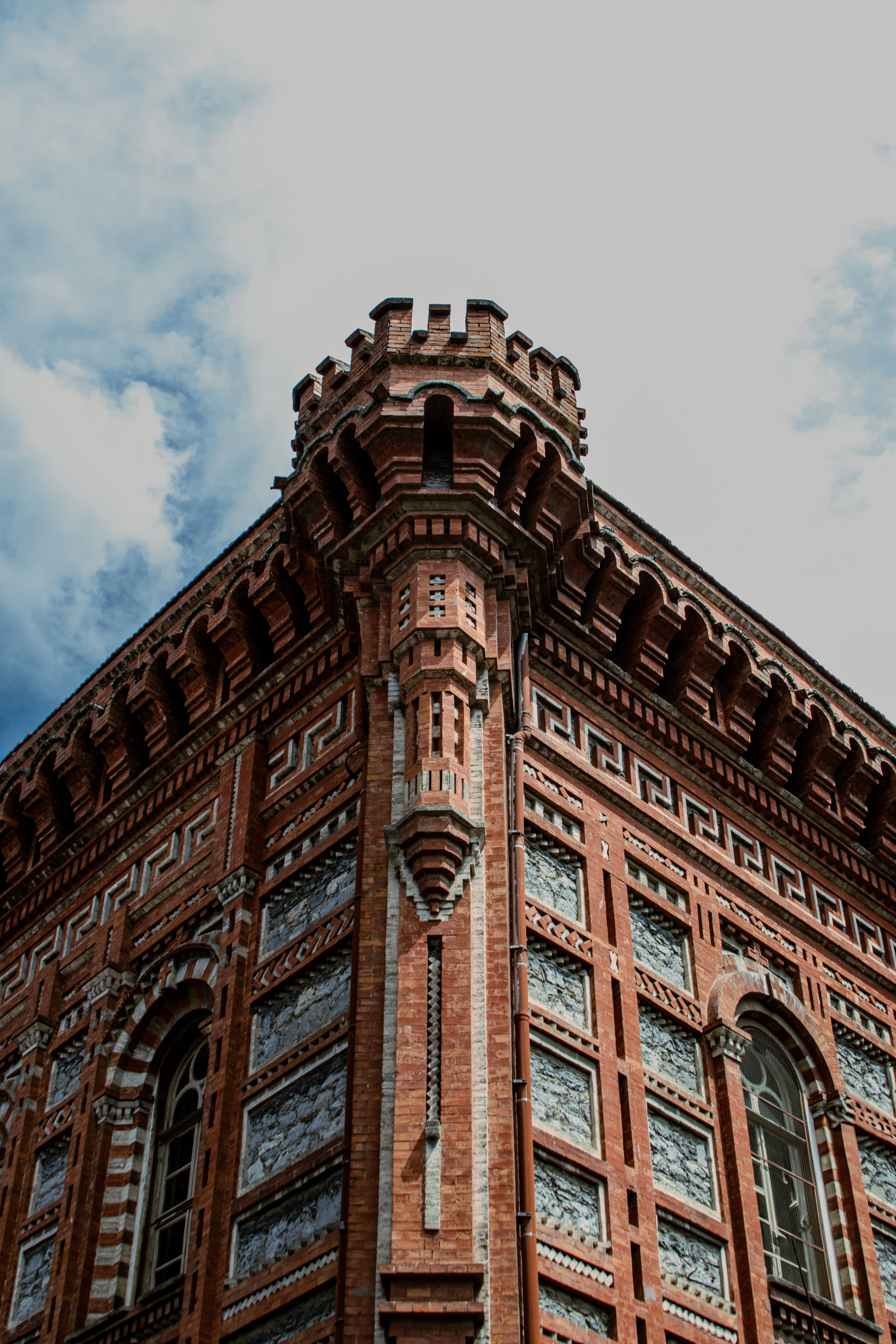 Historic Brick Castle Tower Against Blue Sky · Free Stock Photo