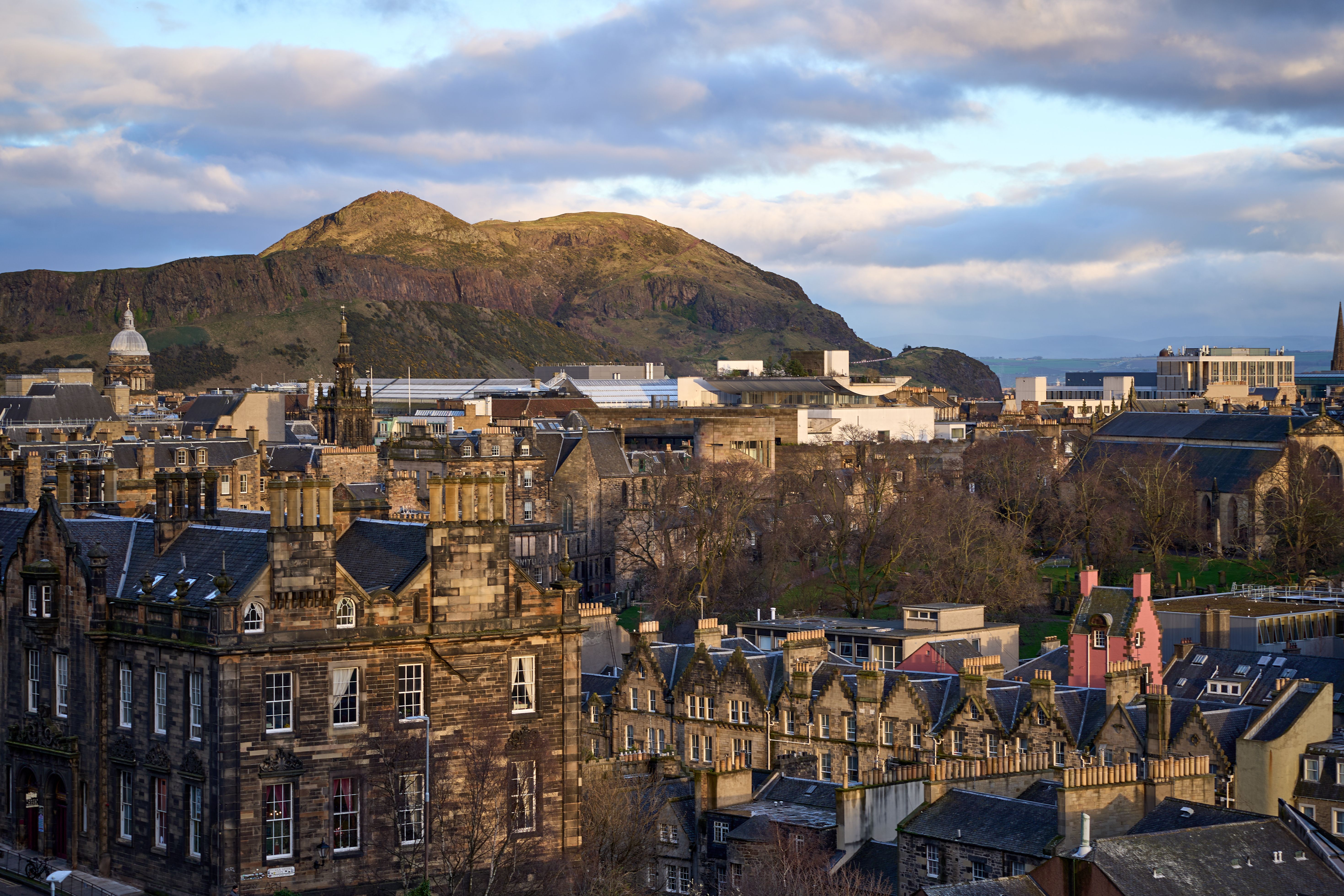 View of Edinburgh cityscape with Arthur's Seat in the background during spring.