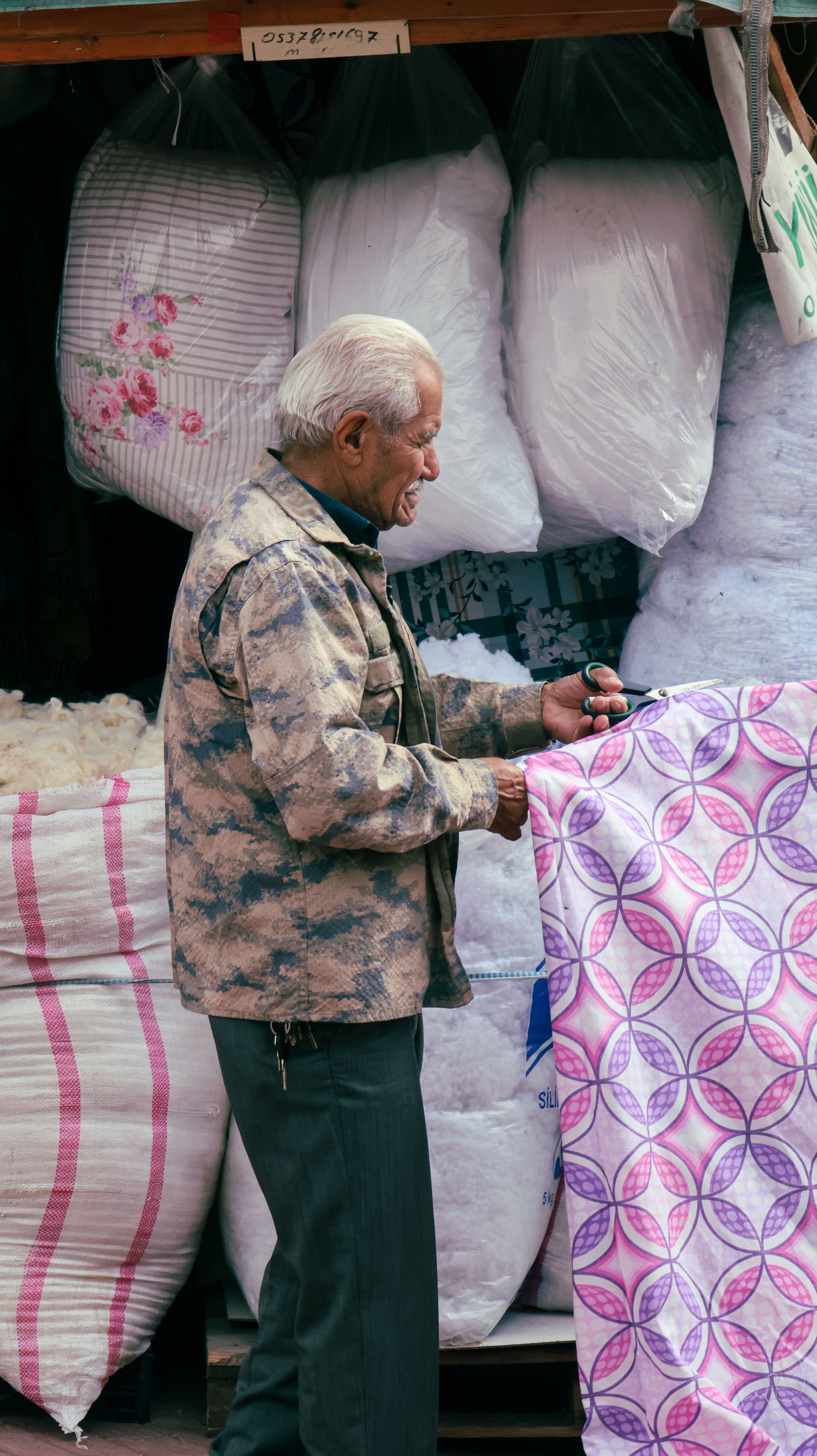 Senior Tailor Cutting Fabric in Textile Shop · Free Stock Photo