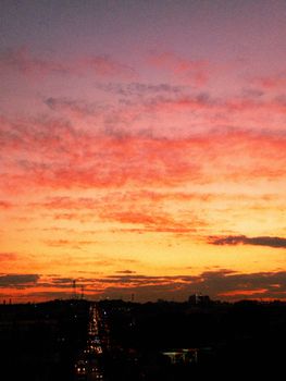 Vibrant sunset skies over a bustling city in Brazil, capturing the beauty of twilight.