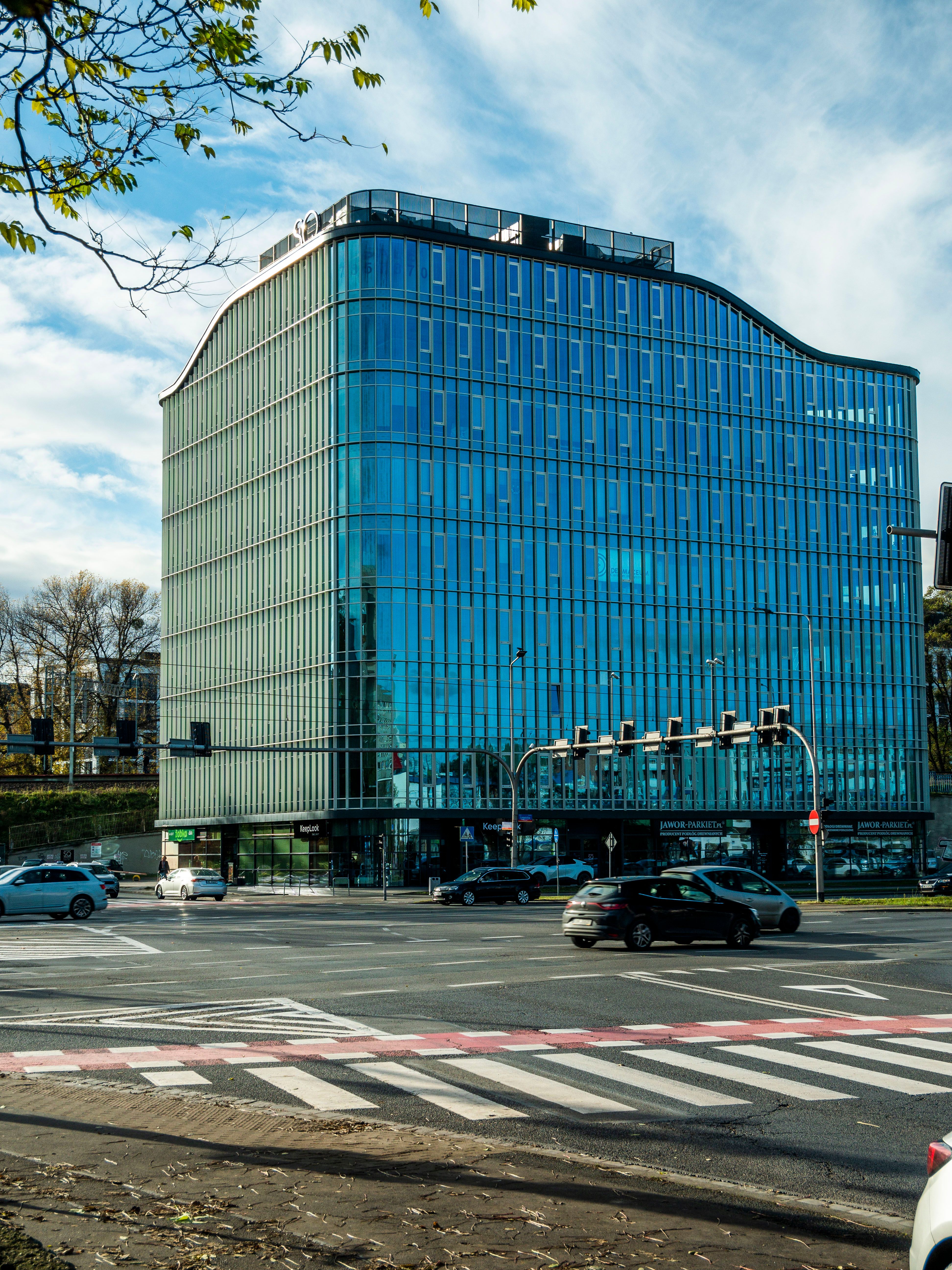Modern Glass Office Building at City Intersection · Free Stock Photo