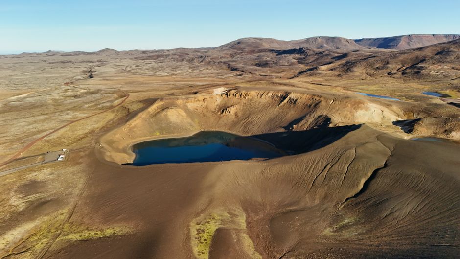 Amazing Helicopter Tour from Reykjavik: Hengill Area with at Site Landing Review Review 2026 - Stunning aerial shot of a crater lake surrounded by volcanic landscapes in Iceland.