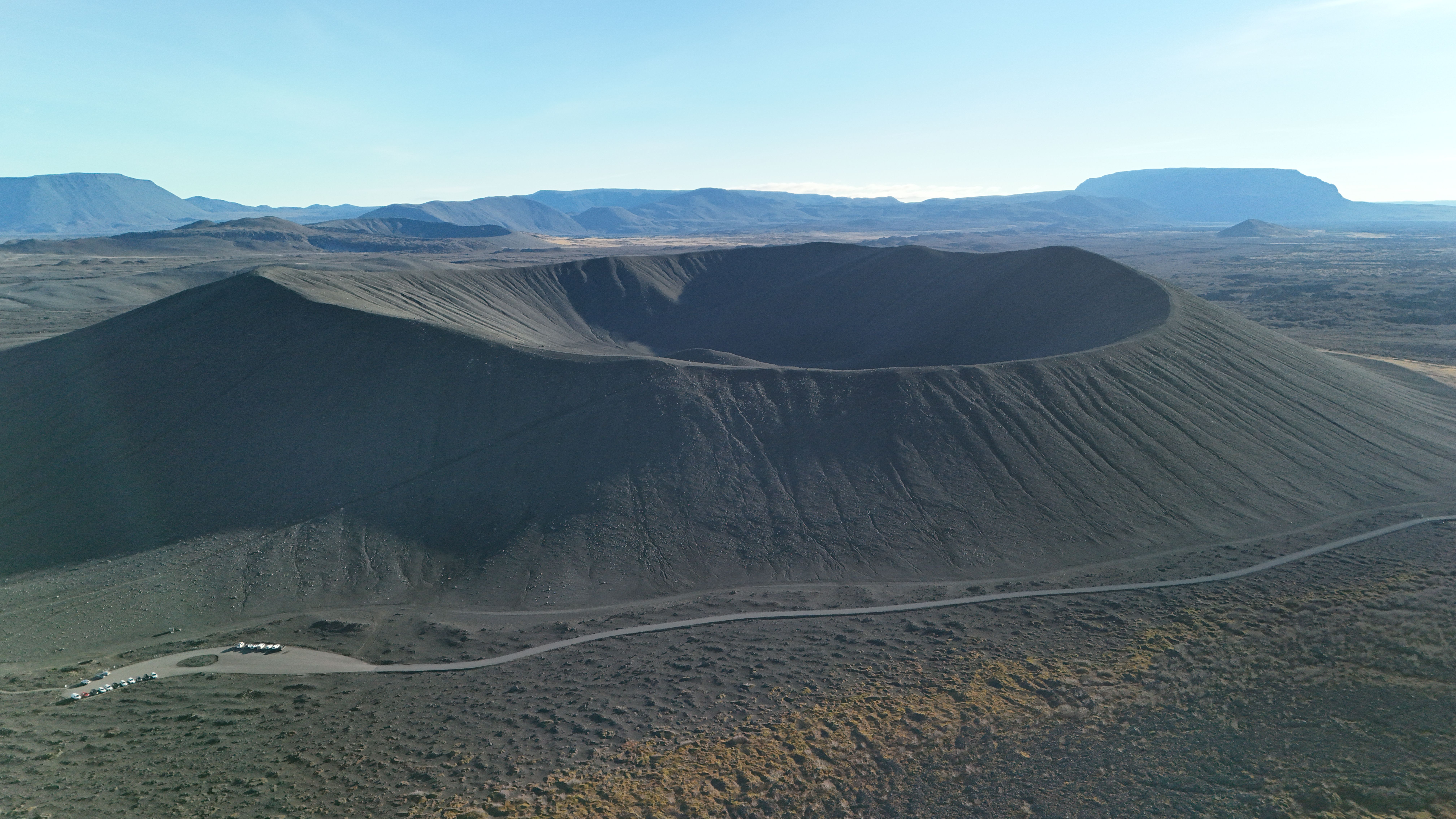 Stunning aerial shot of a volcanic crater with scenic views in Iceland's rugged landscape.