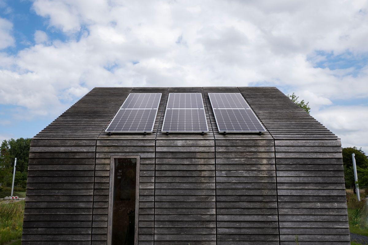 Solar panels on the roof of an eco-friendly wooden off-grid cabin