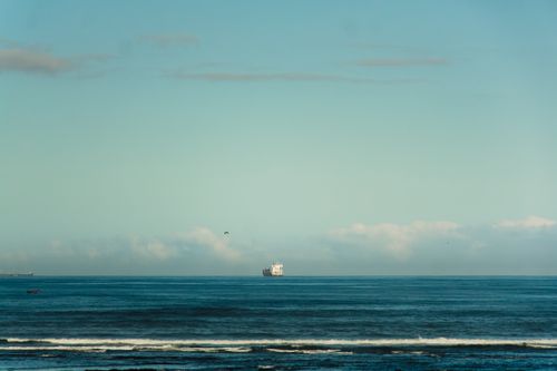 Free Serene ocean landscape from Casablanca, Morocco featuring a distant ship beneath clear blue skies. Stock Photo