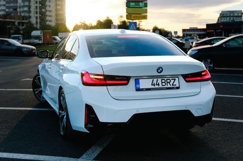 Free White sports car parked outdoors in urban setting during twilight. Sleek and modern design. Stock Photo